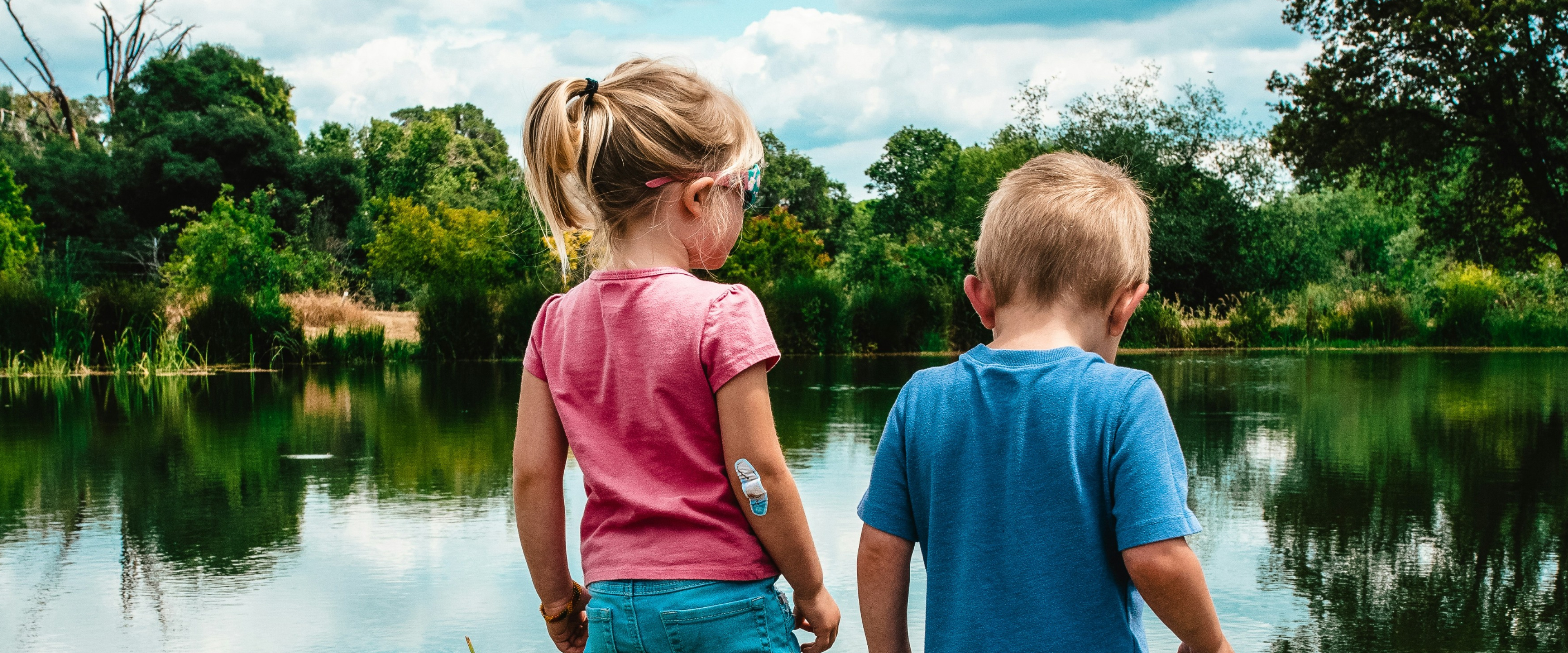 Two children by a pond