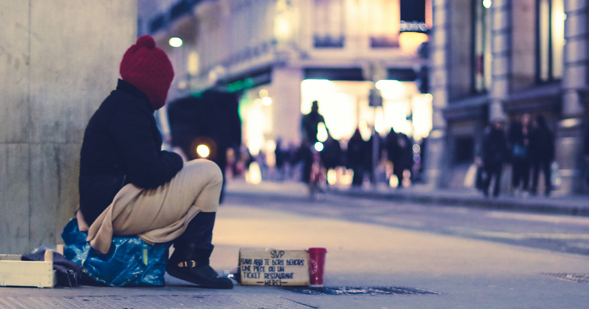 Homeless person sitting on a street