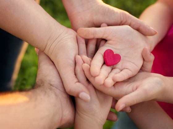 Hands holding a red heart